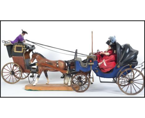 Two 20th century decorative horse and traps both with ceramic horses the first with a lady at the controls and the other with