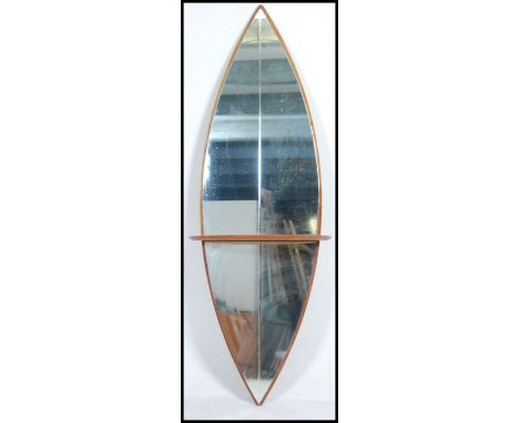 A 1960's full sized floor standing teak wood surfboard mirror. The surfboard shaped frameless mirror having central demi-lune