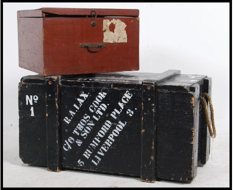 An early 20th century wooden steamer trunk with painted notation for RA Lax  together with another wooden hinged trunk chest.