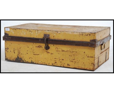 A vintage early to mid 20th century painted tin steamer / travel trunk of rectangular form with hinged lid and carry handles 