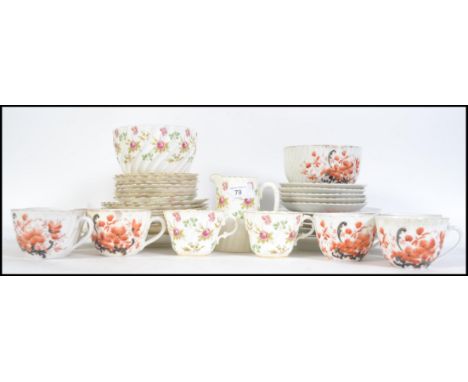 A late 19th century part bone China tea service together with an early 20th century part bone China tea service with floral d