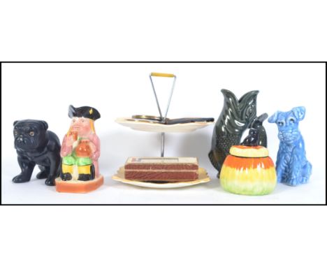 A mixed lot to include a Staffordshire 19th century Bulldog with glass eyes a SylvaC Terrier, cake stand, marmalade pot, Stra