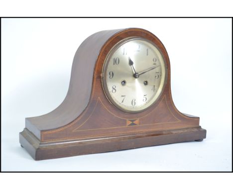 A 20th century Edwardian mahogany inlaid Napoleon mantel clock with inlay detail to front. The clock with an eight day moveme