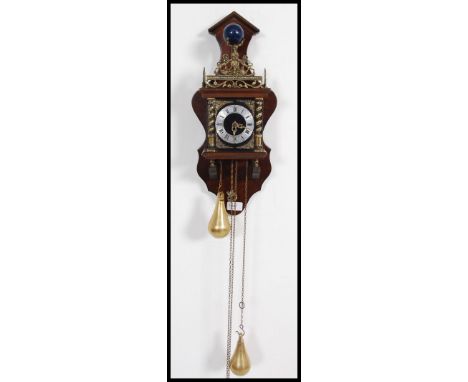 A 20th century mahogany Dutch chain clock with chain and weights having cherub / putti crest and globe. Measures: 50cms high 