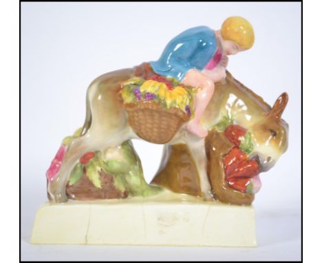 A rare Royal Worcester figurine modelled by Stella. R. Crofts 'boy on a donkey' with saddle bags laden with fruit, puce marks