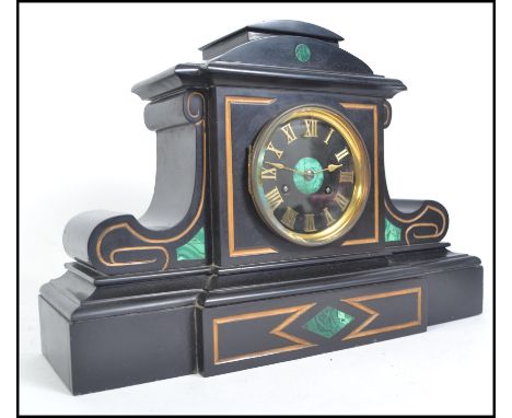 A Victorian black slate and malachite Marti & Co mantel clock having silver notation plaque to the side. The inset brass move