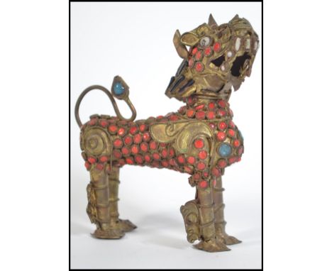 An unusual Chinese scent bottle / scroll holder in the form of a temple dog constructed from gilt metal being adorned with re