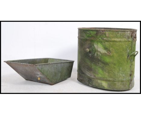 A large early 20th century Industrial galvanised metal water tank of oval form with shaped sides - ideal garden planter. Meas