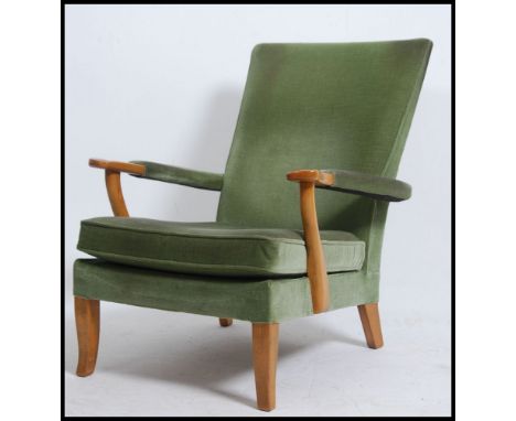 A mid 20th century vintage Parker Knoll open framed armchair having a spring base with original fabric finish being raised on