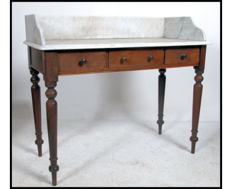 A Victorian mahogany and marble top washstand - writing table desk having mahogany turned legs with white marble top having g