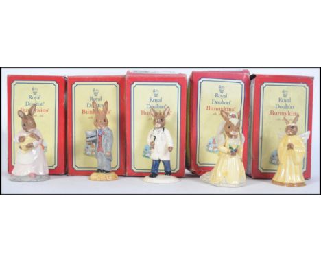 A group of five boxed ceramic Royal Doulton Bunnykins figures to include Groom Bunnykins, Baby Bunnykins, Angel Bunnykins, Do