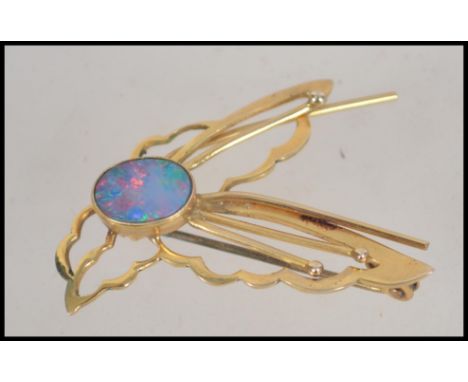 A 9ct gold and opal ladies brooch in the form of a dragonfly. Stamped to verso with roll over clasp pin. Total weight 3.3g