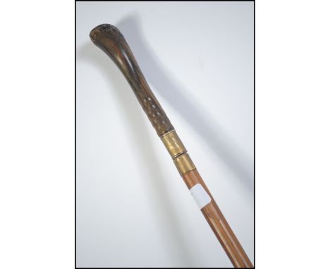 A late 19th century walking cane / finishing stick. The knop pulling out to reveal a short concealed stiletto dagger blade.