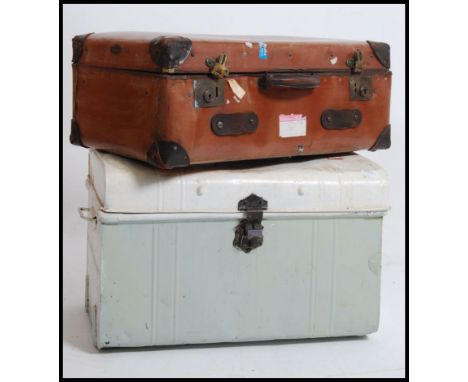 A vintage metal steamer / tack trunk having a hinged top together with a good leather travel trunk of square form. Measures: 