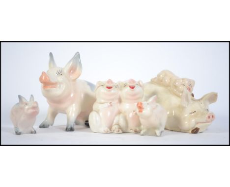 A collection of five ceramic Beswick Pigs to include Piggy back pig and piglet 2746, Pig 832, laughing pigs 2105 and a pair o