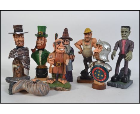A collection of  9 hand carved and painted wooden figurines to include a Frankenstein, Road Worker, Knight, Lord of the Rings