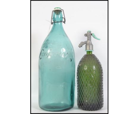 A large vintage 20th century French glass bottle reading Aguas De Lanjaron to the front together with a vintage continental s