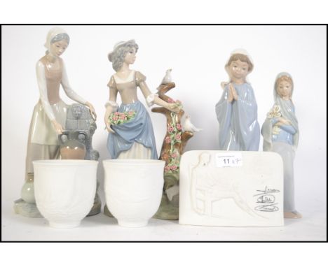 A group of Lladro, Nao and Tangra ceramic figures together with a pair of Lladro collectors beakers etc please see images. Ta