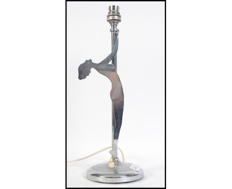 A vintage 20th century Art Deco chrome table lamp. having a circular base with an upright column and a silhouette of a naked 