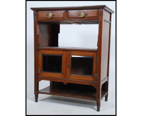 An Edwardian mahogany side cabinet having bevelled plate glass door over open shelf beneath. Measures: 46cms high x 40cms wid