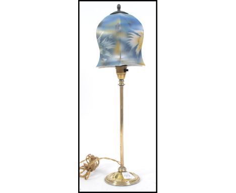 A vintage 20th century brass table lamp. The brass column being supported by a circular base with a stunning Art Deco milk gl