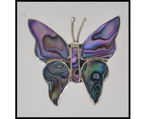 A 20th century Art Deco style silver ( stamped 925 ) brooch in the form of a butterfly decorated with mother of pearl.