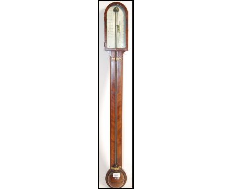 A 19th century Georgian mahogany stick barometer. The silvered barometer dial marked for Singers of London flanking brass adj