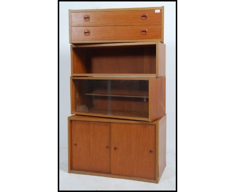 A retro mid century teak wood PS style modular wall system comprising of a bank of 2 drawers, a glass fronted cabinet, a shel