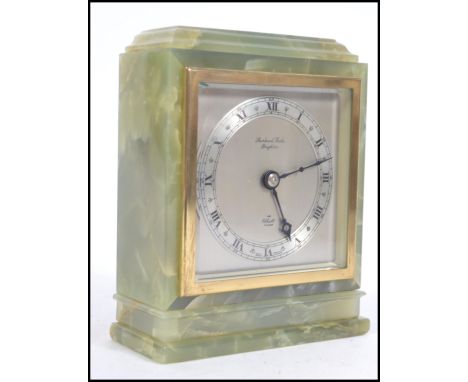 An early 20th century green marble mantel clock by Elliott. Silvered dial with notation for the retailer - Shorland Fooks of 