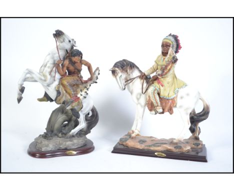 A pair of large ceramic Native American Indian figures on horse back. Both set on naturalistic plinth bases raise on a wooden