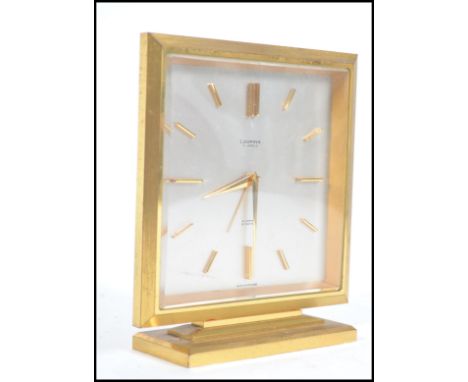 A 1930's Art Deco well made Looping of Switzerland heavy brass quality mantel clock with baton numerals, central notation for