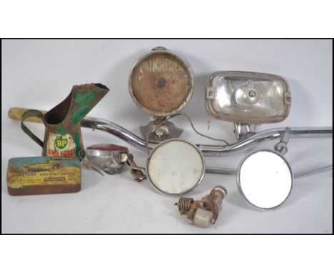 A collection of motoring related wares to include a cow horn motorcycle handlebar, Oil can, LIghts to include a Miller roof m