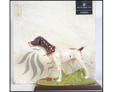 A Royal Doulton ceramic figure of a Pointer dog set on a naturalistic plinth with wooden plinth from the Gun dog Collection n