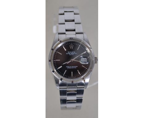 A Rolex Oyster Perpetual Date chronometer wristwatch having a black dial with baton numerals having convex eye date aperture.