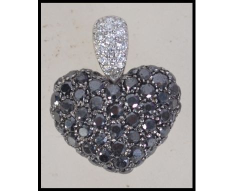 A Chopard 18ct white gold and diamond figural pendant in the form of a heart encrusted with white and black diamonds in a pie