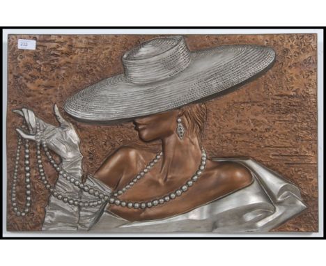 An Art deco style molded 3D effect plaster picture of a young stylistic lady in hat smoking a cigarette wearing a string of p