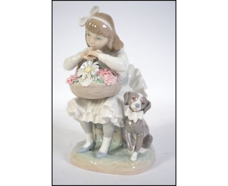 A Lladro figurine of a seated girl with a cream ruffled skirt holding a floral basket containing flowers including a large da