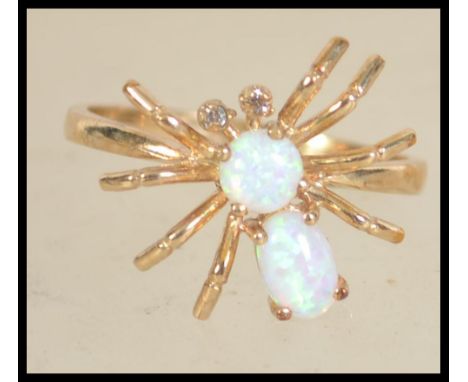 A hallmarked 9ct gold and opal and figural ring in the form of a spider. with opal body and head and diamond eyes. Hallmarked