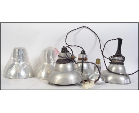 A group of five retro 20th century brushed aluminium pendant conical light fixtures / shade.