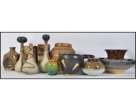 A collection of studio pottery of various shapes and designs from various potters with marks such as TW / WT, SGR, John Campb