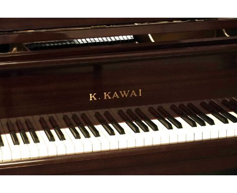 A K. Kawai baby grand piano, raised on three square tapered legs terminating in brass castors, with brass pedals, 151 x 173 x