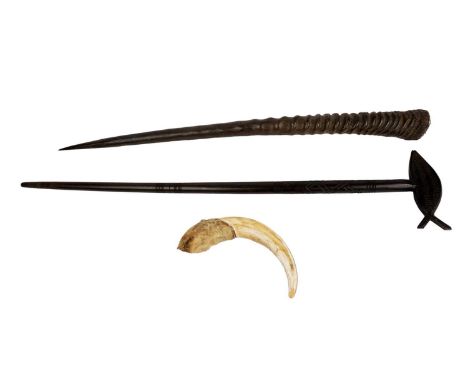 A 20th Century decorative carved wooden stick, with the top carved in the form of a fish, 88cms long; together with a warthog