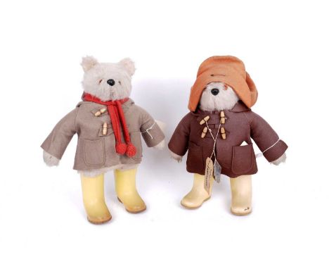 Two Gabrielle Designs Paddington Bear teddy bears: one in a beige coat, red scarf and yellow Dunlop wellington boots; the oth