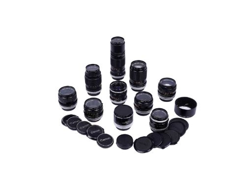 A collection of Canon breech-lock lenses, comprising: a Canon FD 50mm f1.4 lens and hood; a Canon FD 35mm f3.5 lens; a Canon 