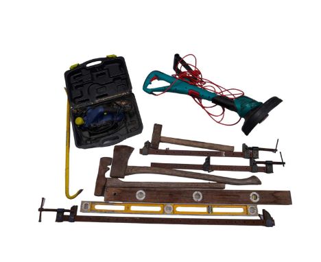 A selection of tools, to include: a boxed electric planer; a strimmer; three sash clamps; two spirit levels; a crowbar; and o