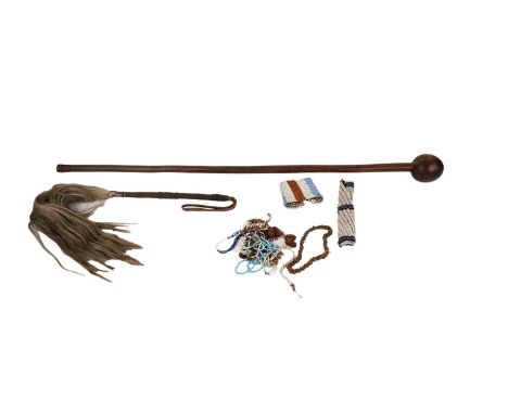 A collection of early 20th Century African beadwork jewellery; together with a horsehair flyswat; and a knobkerrie, 96cms.