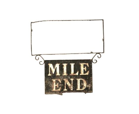 A vintage cast metal hanging sign, reading 'Mile End', white letters on a black ground, 63cms wide.
