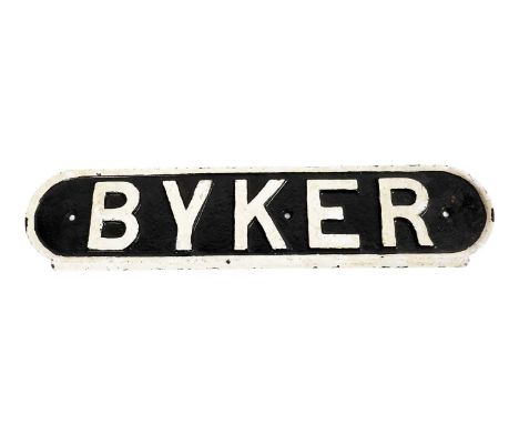A vintage cast iron railway sign for 'Byker', black letters on a white ground, 48cms wide.