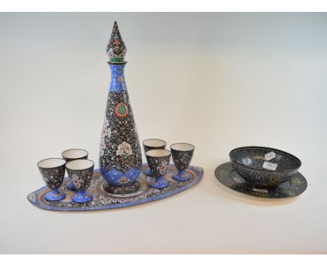 An Indian enamel liqueur set, comprising a decanter and stopper, six goblets and a tray, and a similar bowl and plate (10)
