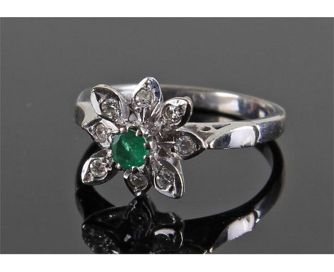 18 carat white gold diamond and emerald set ring, the central emerald raised above diamond set leaf background, ring size K